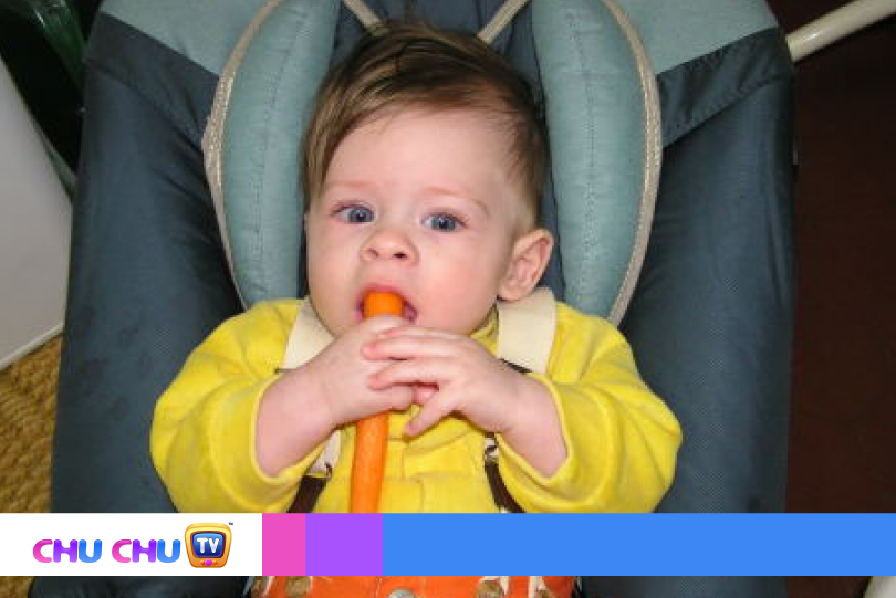 baby gnawing a carrot