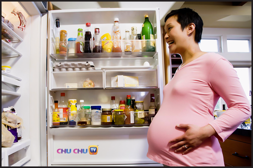 pregnant lady looking into a fridge